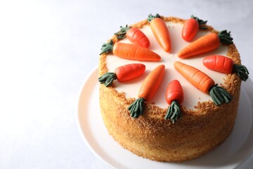 Delicious carrot cake on light table, closeup. Space for text
