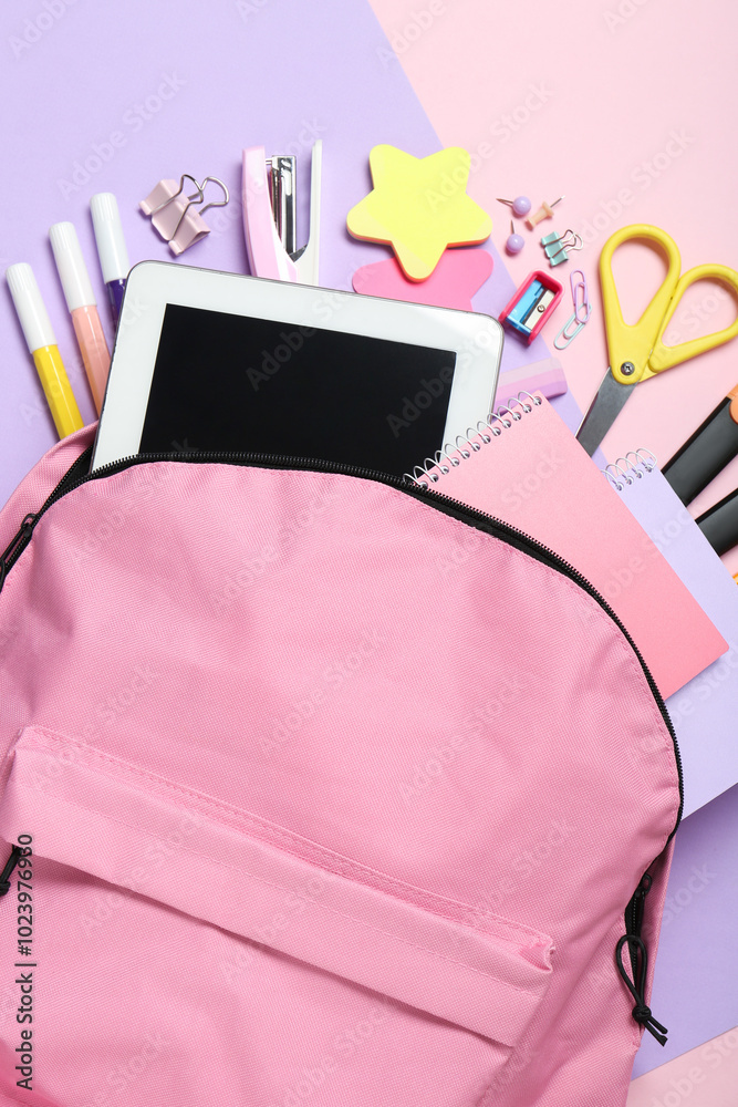 Wall mural Backpack and different school stationery on pink background, flat lay