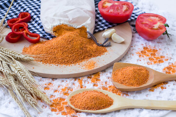 Traditional Turkish Homemade Dry Soup Tarhana grains in cloth bag on wooden tray with sliced tomato and red pepper