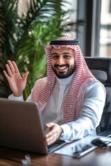 Smiling Arab Man in Traditional Clothing Working on a Laptop