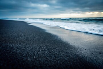 Obraz premium Highly detailed black sand beach with fine grains in monochrome, showcasing depth of field