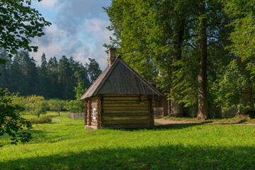 View of the traditional log Russian house in the Mikhailovskoye estate of the Pushkin Museum-Reserve on a sunny summer day, Pushkinskiye Gory, Pskov region, Russia