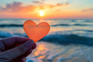 Fototapeta premium Heart Shaped Paper at Sunset on the Beach