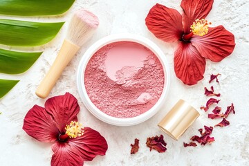 Aesthetic flat lay of pink blush powder, brush, and hibiscus flowers on a light background, perfect for beauty and skincare themes.