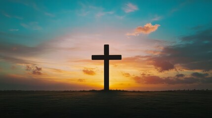 Silhouette of a cross against a vibrant sunrise sky with orange and blue hues, symbolizing faith and hope. Concept of spirituality, religion, peace, and new beginnings