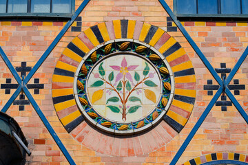 Tiled cocoa flower on the facade of the Saulnier watermill in the former Menier Chocolate Factory in Noisiel, Paris Region, France