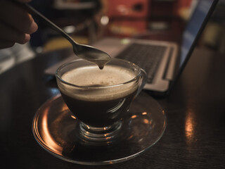 Coffee break time with laptop on wooden table in coffee shop. Recreation relaxation concept.