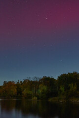 Night sky aurora photograph. Colorful northern lights landscape.	
