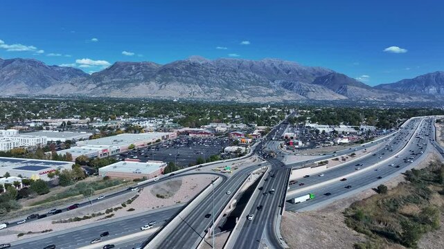 Aerial American Fork Utah highway intersection traffic 2. Central Utah city. Economic center for residential  retail shopping. I-15 Interstate Freeway. Growing population, homes, business and schools.