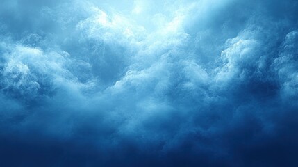 Obraz premium Dramatic blue sky with heavy, dense clouds, a ray of light shining through.