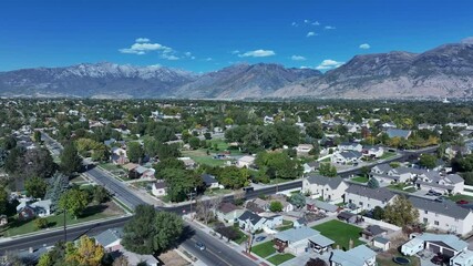 Aerial American Fork Utah residential neighborhood pull 1. Mount Timpanogos. Utah city. Economic center for residential retail shopping. Growing population, homes, business and schools. Neighborhood.