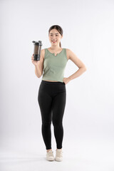 Full body image of young Asian girl wearing sports outfit and posing on white background