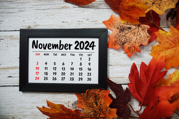 November 2024 monthly calendar maple leaf decoration on wooden background