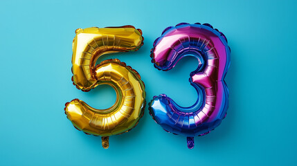 Fototapeta premium Rainbow foil balloon number fifty three. Top view. Colored number on blue background.