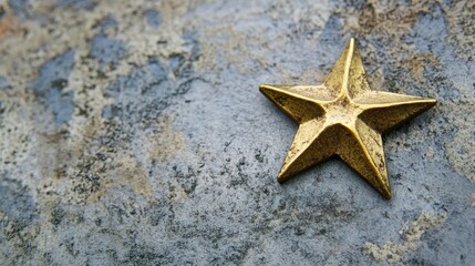 A golden star sits on a textured surface.