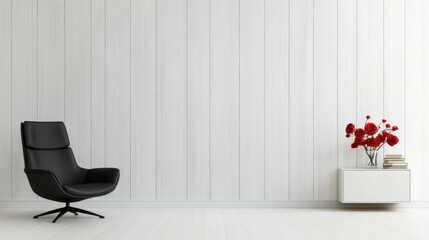 A black armchair sits in front of a white wood-paneled wall with a white floating shelf holding a vase of red flowers.