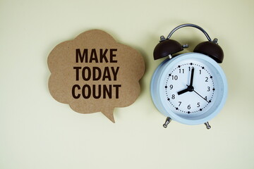 Make Today Count text on speech bubble with alarm clock on yellow background