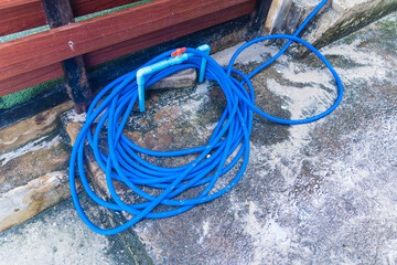 Ready for Watering: Garden Hose on Concrete