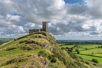 Afternoon sun shines down on the ancient church of St. Michael de Rupe in Brentor, Dartmoor
