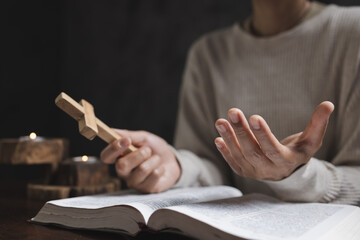 Fototapeta premium A woman prays with a Bible in a room. her faith unwavering as she prayed and worshiped God, religion concept.