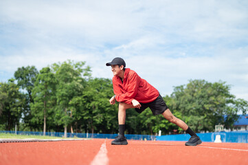 Young cool Asian men in sportswear stretching in sports fields in various poses in bright sunny morning to maintain health and healthy lifestyle. morning exercise healthy and active living concept