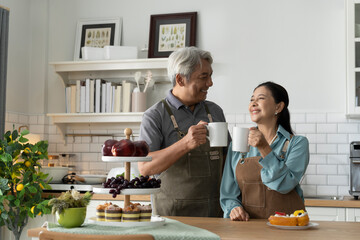 Happy Senior Couple Enjoying Coffee in Kitchen