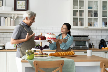 Senior Couple Celebrating with Homemade Cake in Kitchen