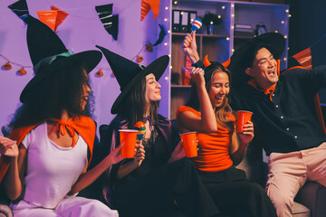 Joyful office Halloween party with coworkers in costumes, celebrating with drinks and laughter, fostering teamwork and festive spirit