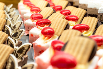 Savoiardi pastries with chocolate slices and glazed nuts