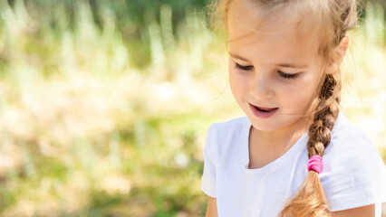 Child girl walking in park outdoor enjoying summer flowers family lifestyle vacations kid 4 years old long hair portrait in harmony with nature