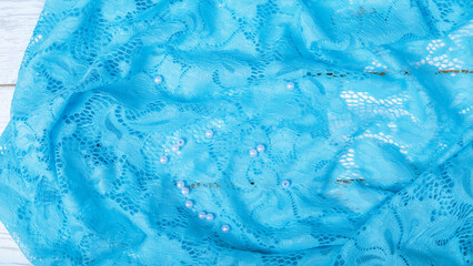 Background made of light blue cotton fabric. Blue simple textile template with neat folds, copy space.