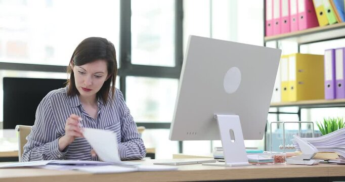 Woman manager works in office with computer with documents