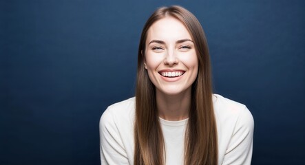 Obraz premium Young white woman with soft features and long straight hair smirking dark blue background