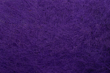 Close-up of a purple textured surface with fibrous material creating a detailed abstract pattern.