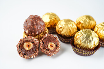 chocolate and hazelnut confectionery balls. chocolate sweet made. Chocolate candies in a gold wrapper