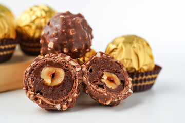 chocolate and hazelnut confectionery balls. chocolate sweet made. Chocolate candies in a gold wrapper