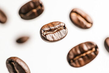 A dynamic shot of roasted coffee beans seemingly floating in mid-air against a bright