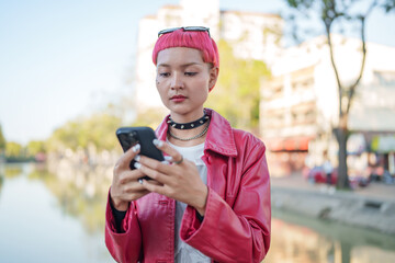 Traveler girl using mobile phone on street in city Fashion gen z asian woman .Technology connection...