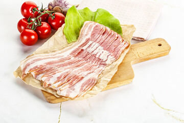 Sliced pork bacon oved board