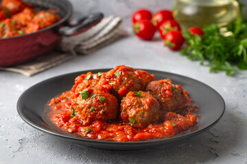 Delicious fresh meatballs in tomato sauce with salt, spices and herbs