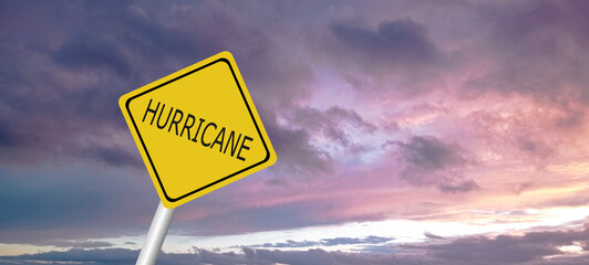 Hurricane Idalia warning sign against a powerful stormy background with copy space. Dirty and angled sign with cyclonic winds add to the drama.hurricane season sign on cloudy background