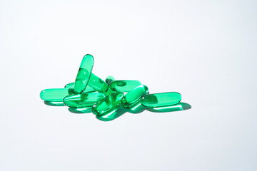 Vitamin E softgel capsules, vitamin D3, fish oil, omega 3, Green oil pills on a white background