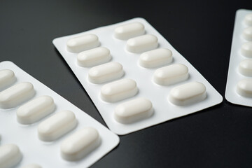 Antibiotic pills Medicine tablet capsules in blister pack on a black background