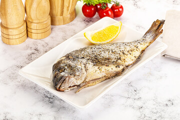 Baked Dorado fish served lemon