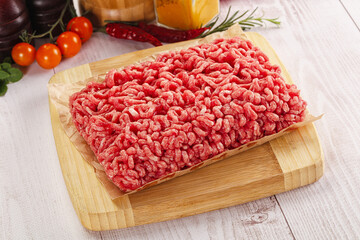Raw minced beef meat over board
