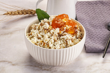 Curd with granola and orange jam