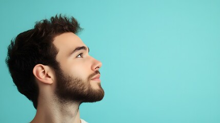 Obraz premium 32. A man with a serene expression, reflecting contentment, against a light blue background.