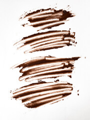 Abstract brown brush strokes on white background for creative design projects