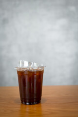 A glass of iced black coffee in plastic glass, clean composition, Minimal style
