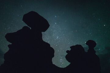 Starry Night Sky Behind Silhouette Of Hoodoos In A Desert